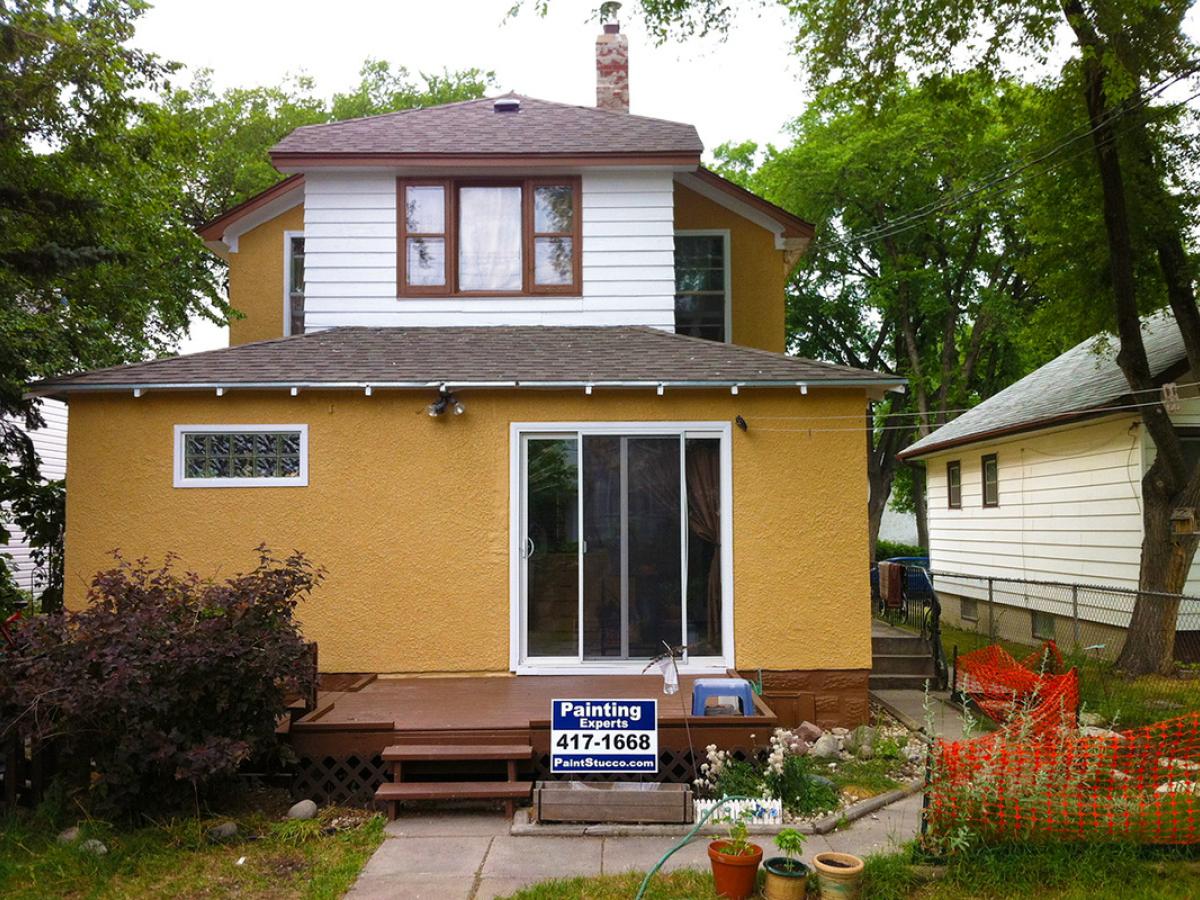 After (Rich colored stucco & restored wood siding)
