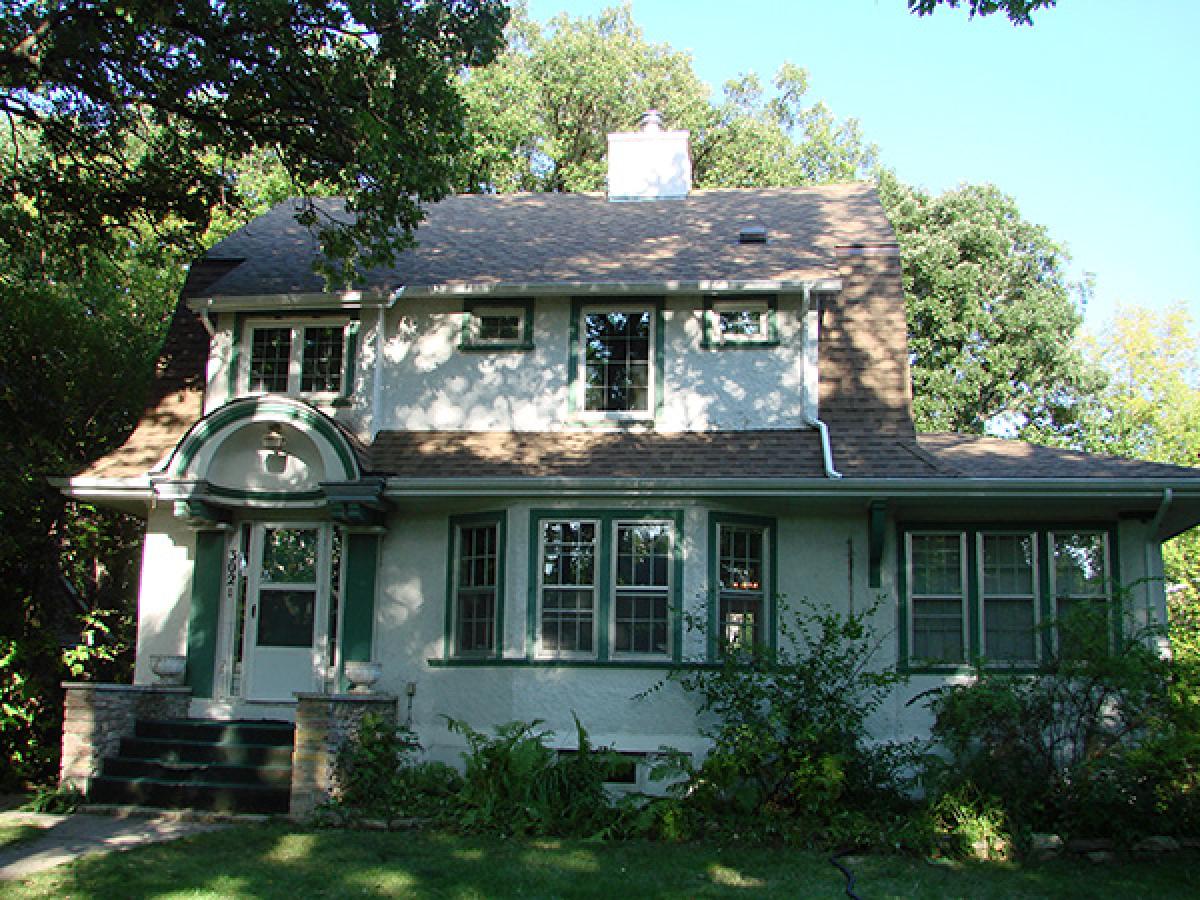 Before (Outdated stucco & window trims in river height house)