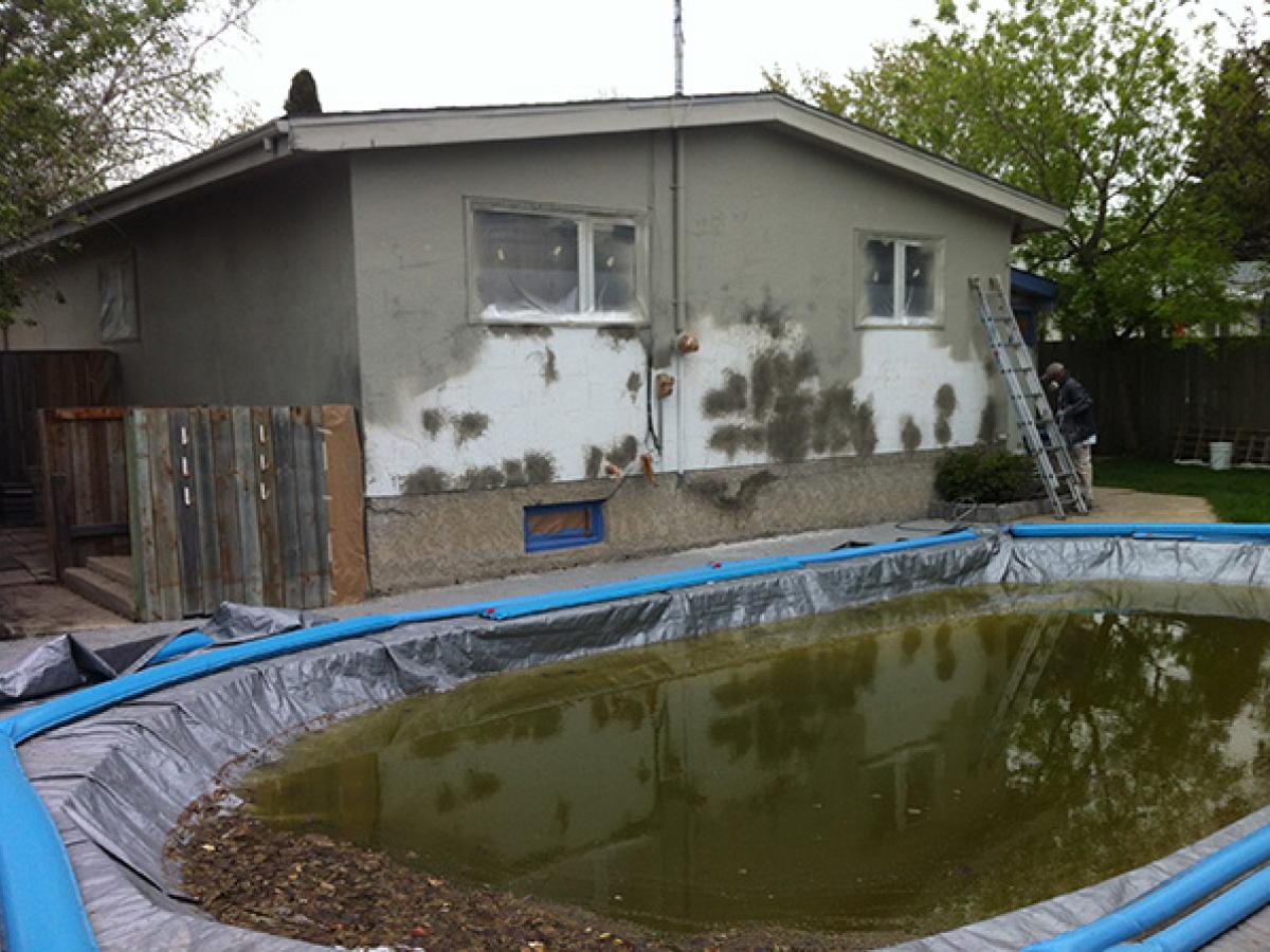 Before (Deteriorated stucco house)